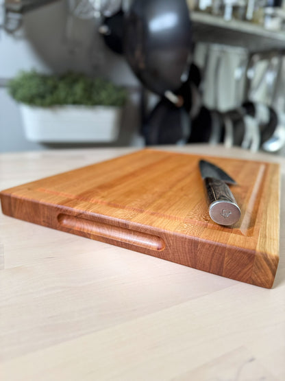 Cherry edge grain cutting board flat lay with knife, handmade hardwood Ottawa