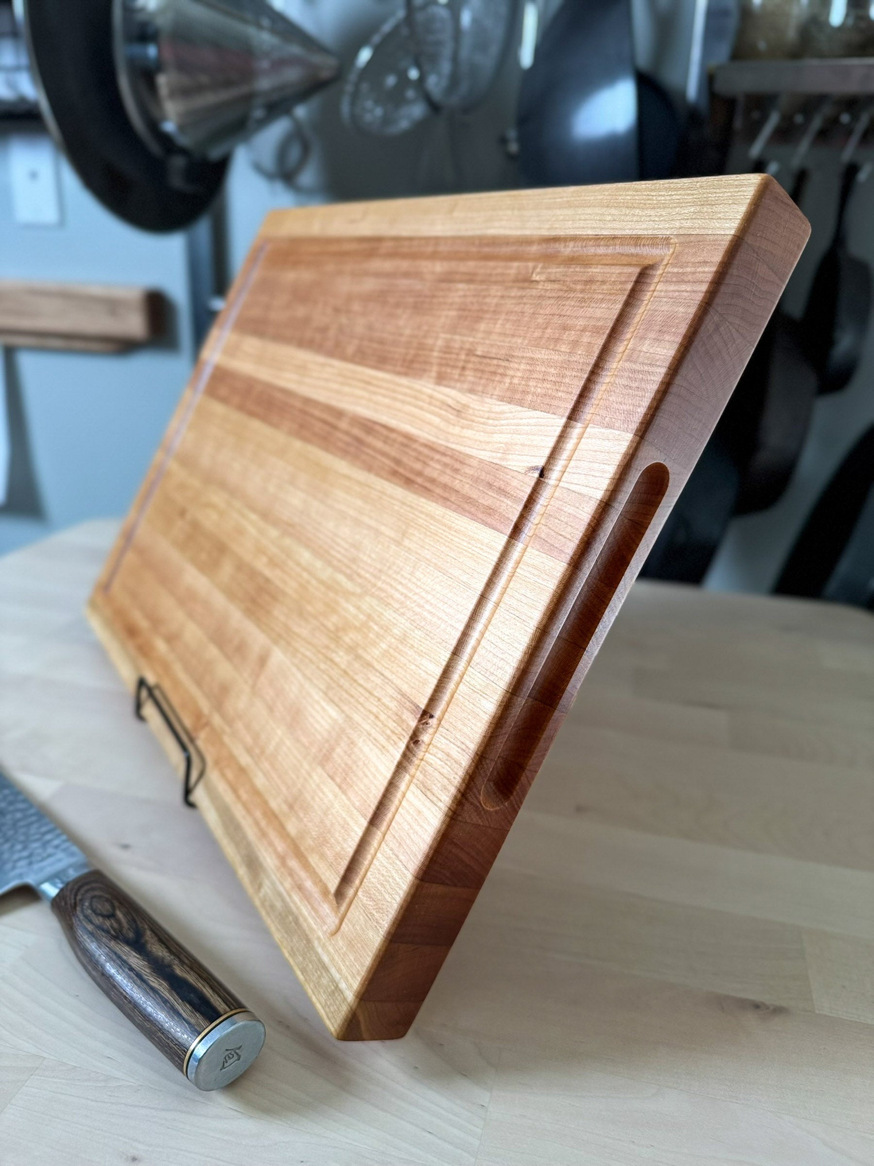 Handmade cherry edge grain cutting board standing upright, Ottawa Lumber Bin