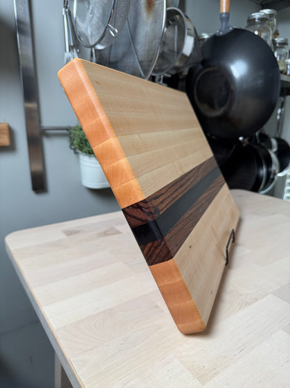 Edge detail of the Cottingham edge grain cutting board in maple, walnut and zebrawood.