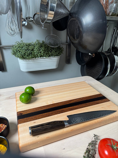 Cottingham edge grain cutting board with chef's knife, crafted from maple, walnut and zebrawood.