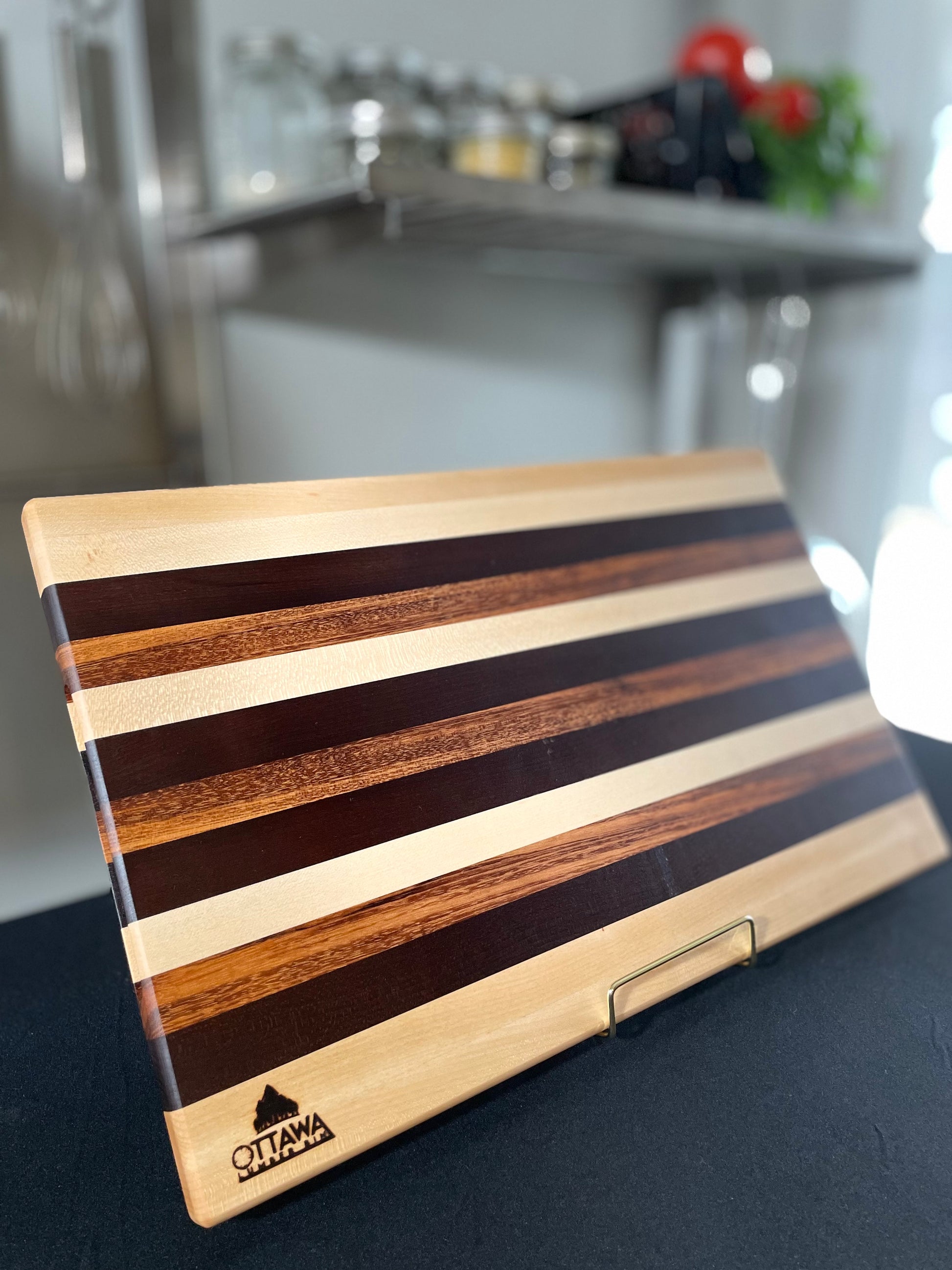 Standing edge grain charcuterie board handcrafted from maple, walnut and tigerwood.