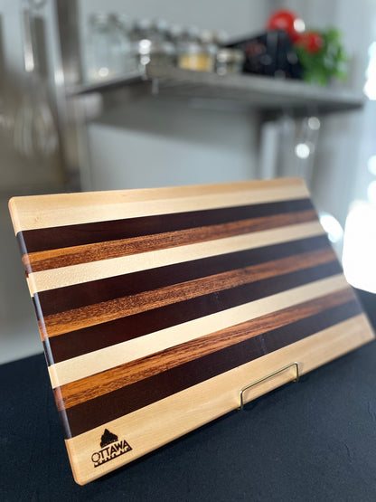 Standing edge grain charcuterie board handcrafted from maple, walnut and tigerwood.