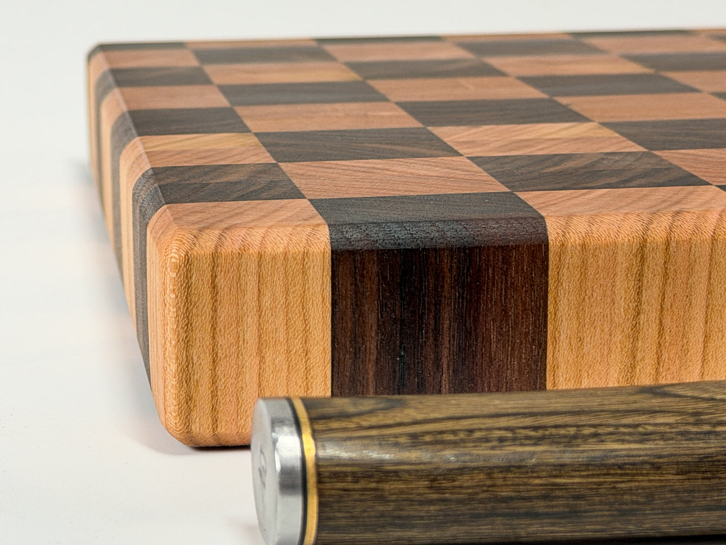 Tight corner detail of end grain butcher block showing alternating hardwood species, handmade in Ottawa