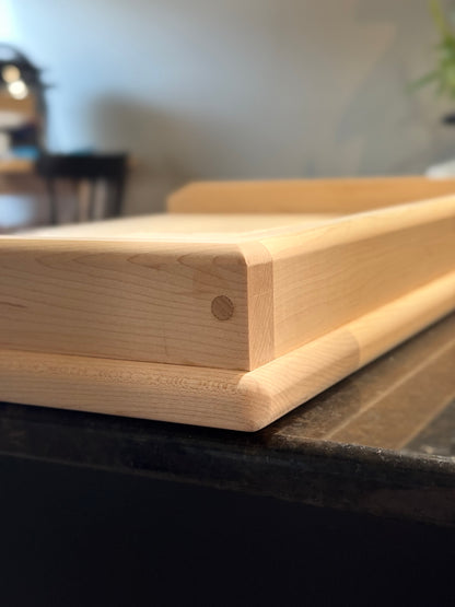 Corner view of handcrafted maple pierogi board showing raised lip and dowel joinery