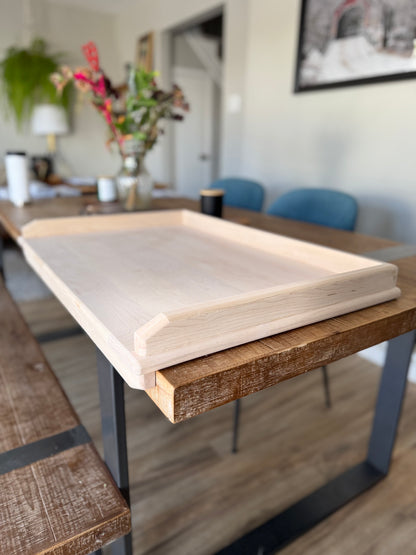 Maple pierogi board displayed on side view to show the edges of the board