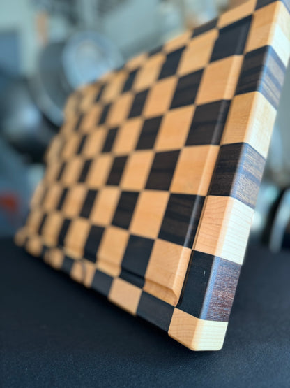 Angled detail of a handcrafted maple and walnut end grain checkerboard cutting board.
