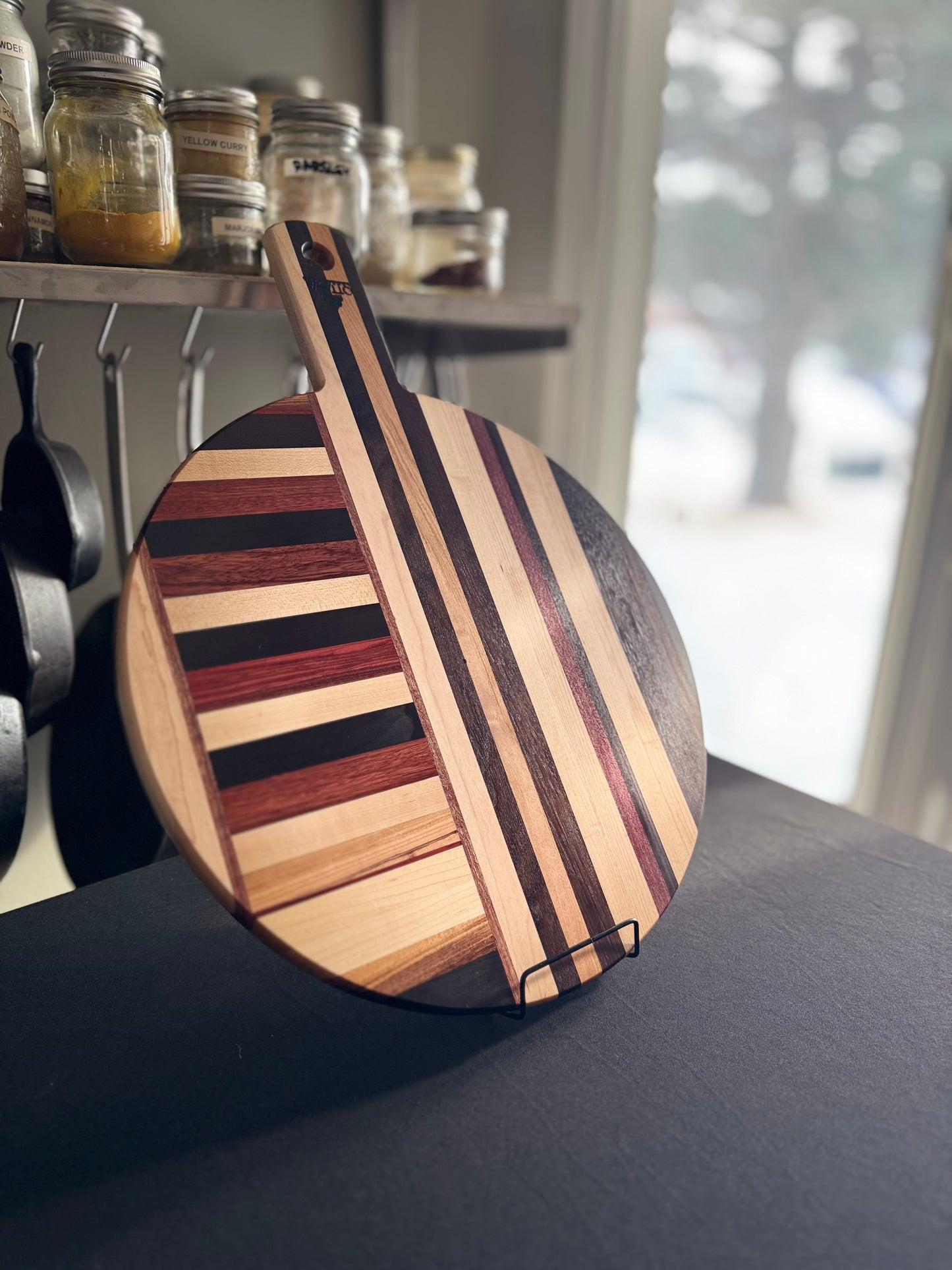 Large round hardwood pizza board handcrafted in Ottawa from mixed species offcuts