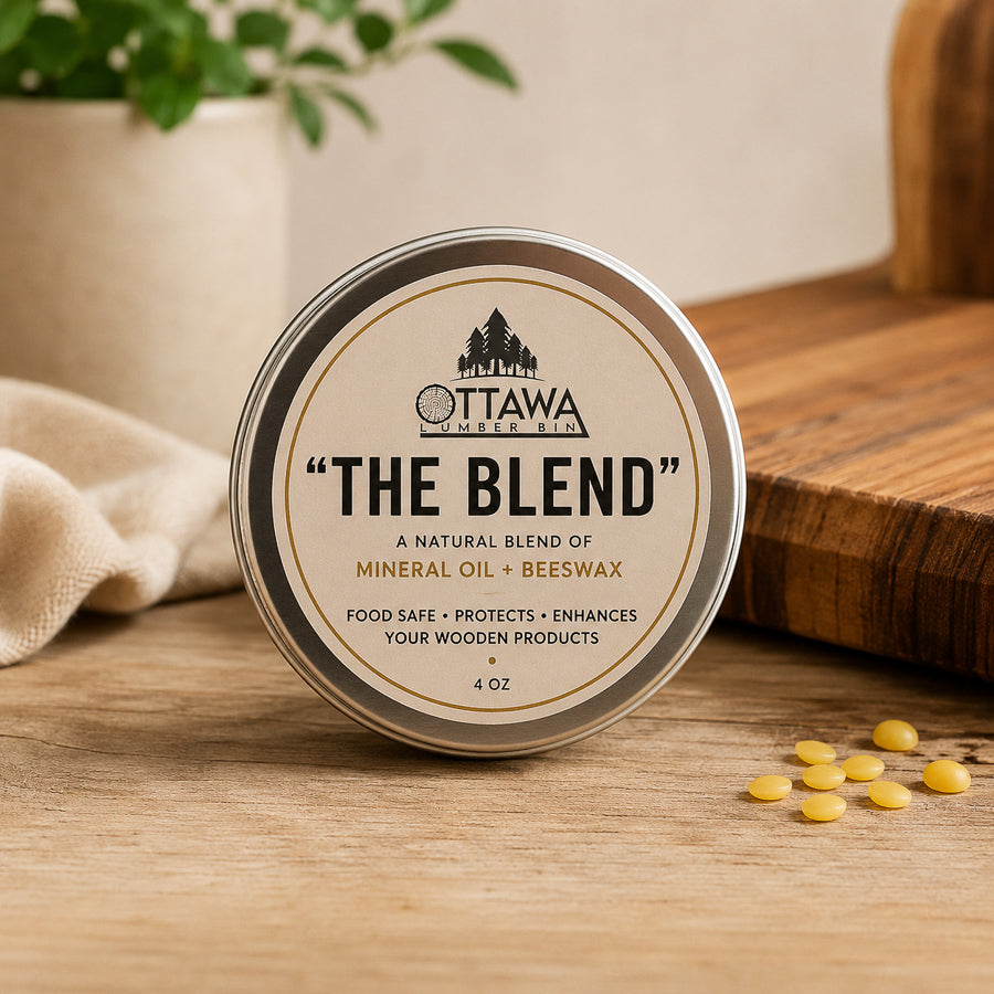 Ottawa Lumber Bin The Blend cutting board conditioner made with food-safe mineral oil and beeswax, shown in a premium tin beside a wooden cutting board.