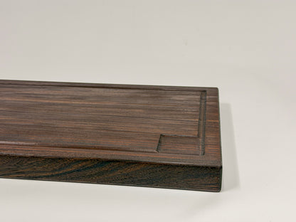 Close-up of a walnut edge-grain BBQ cutting board with routed drip groove and thick profile.