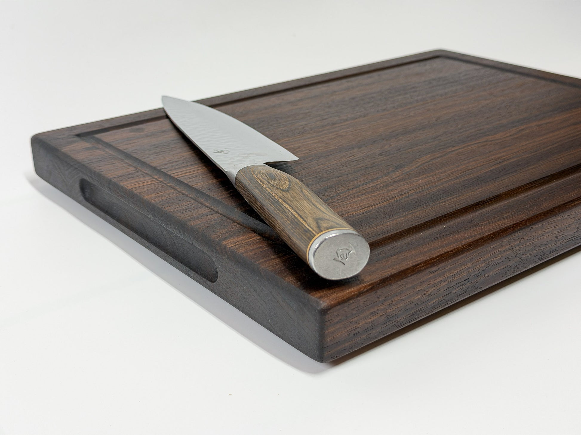 detail of handmade walnut edge grain cutting board showing juice groove and grain