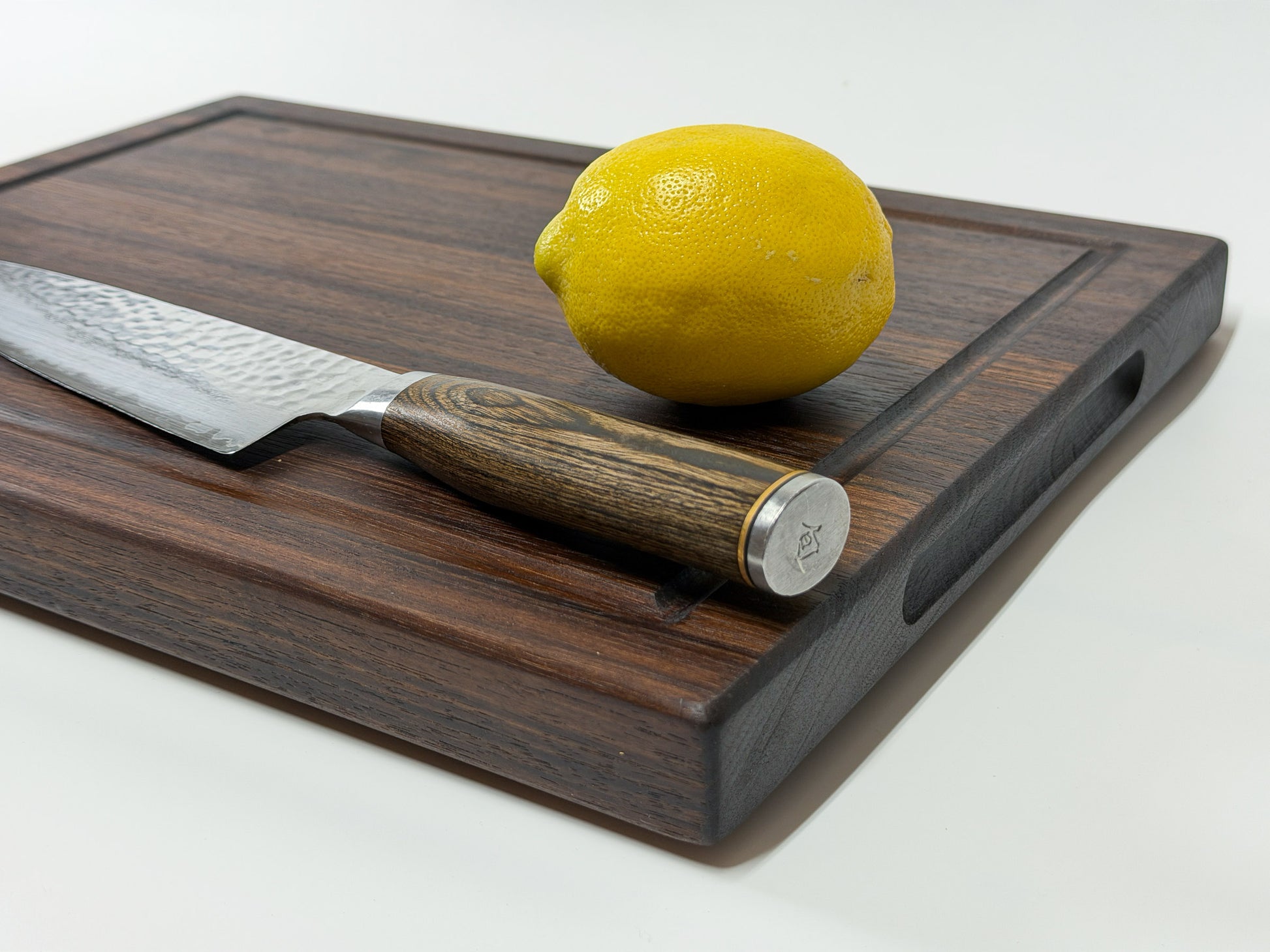 Handmade walnut edge grain cutting board with chef knife and lemon, Ottawa Lumber Bin