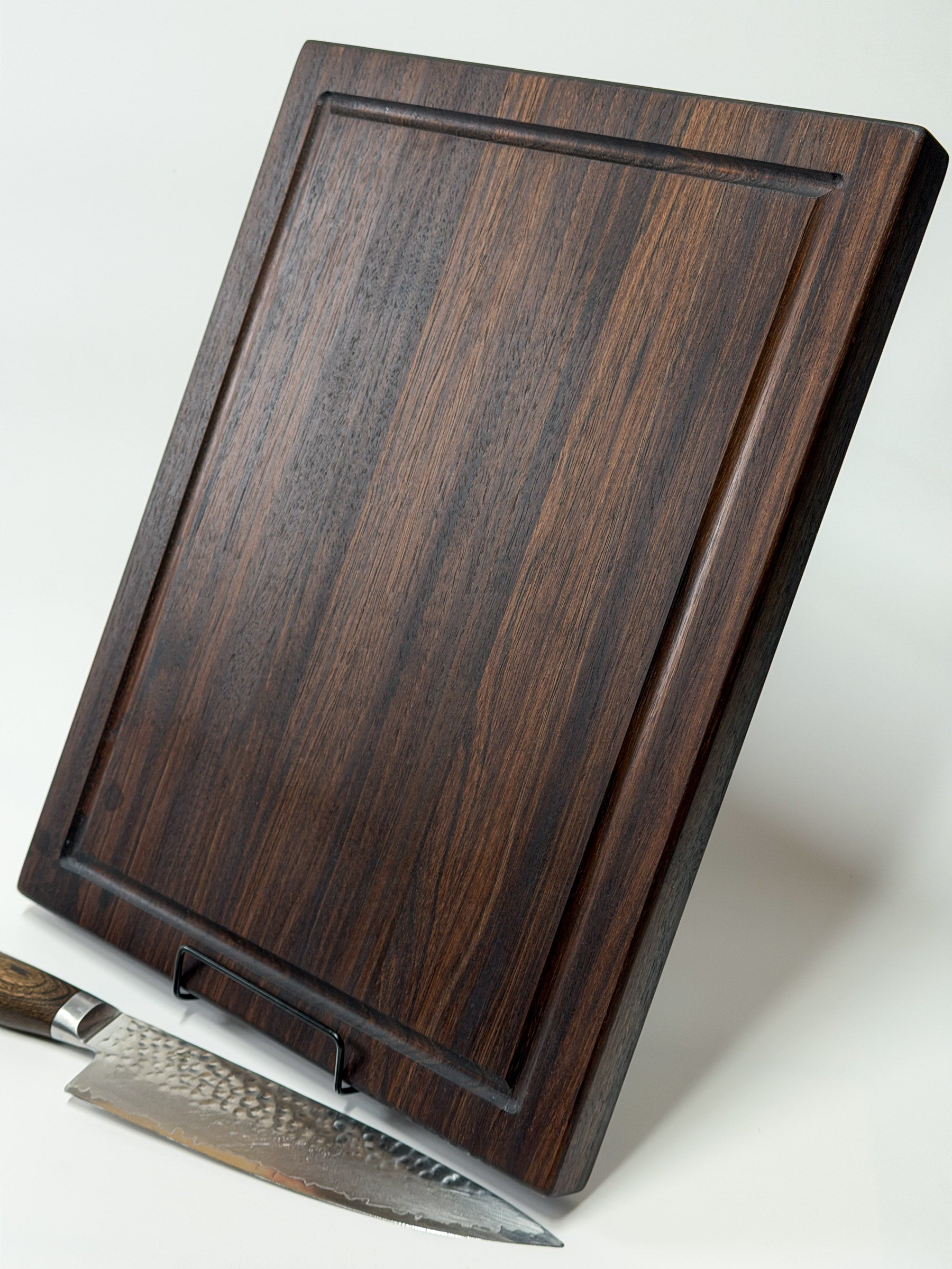 horizontal standing profile of walnut edge grain cutting board showing thickness and juice groove depth