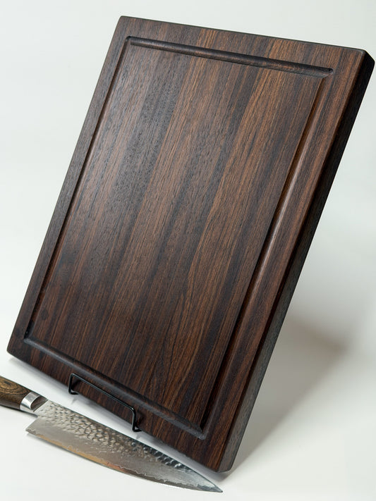 horizontal standing profile of walnut edge grain cutting board showing thickness and juice groove depth