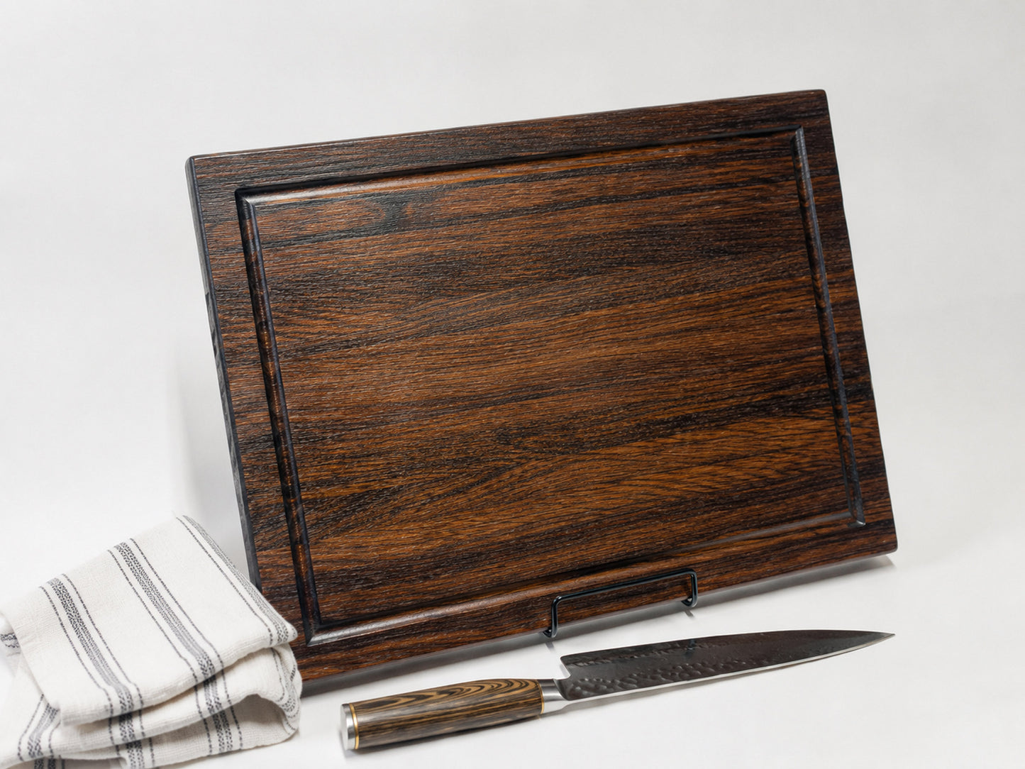 Side profile of walnut edge grain cutting board showing thickness and juice groove depth