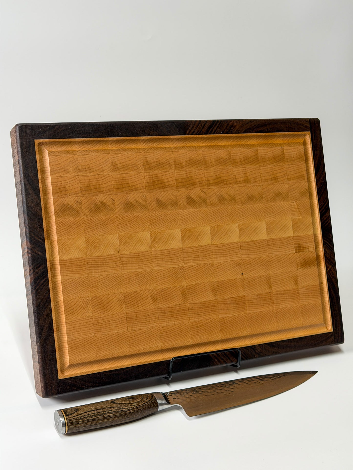 Handmade walnut and maple end grain cutting board standing upright, Ottawa Lumber Bin