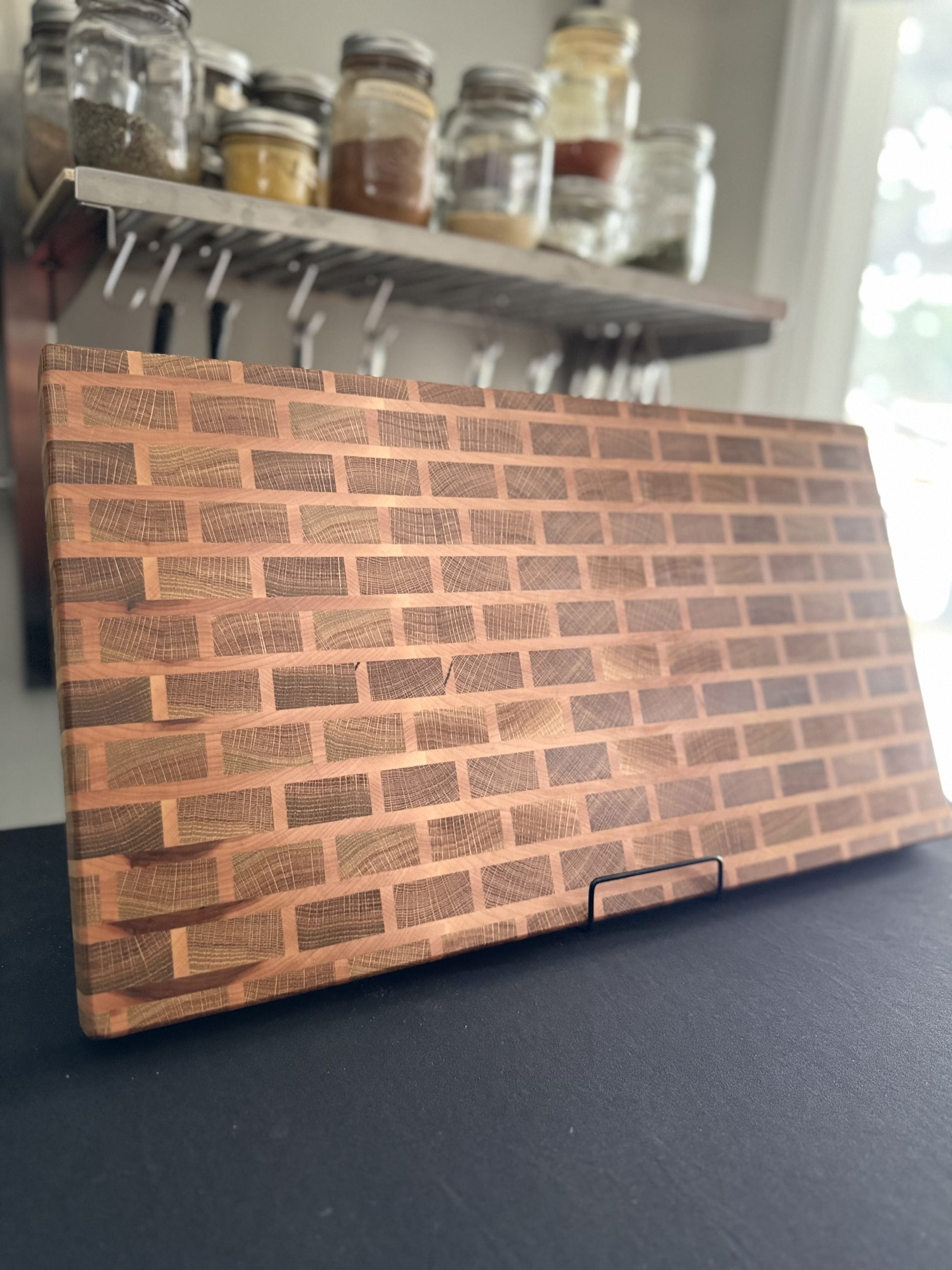 Handcrafted white oak and cherry end grain brick pattern cutting board.
