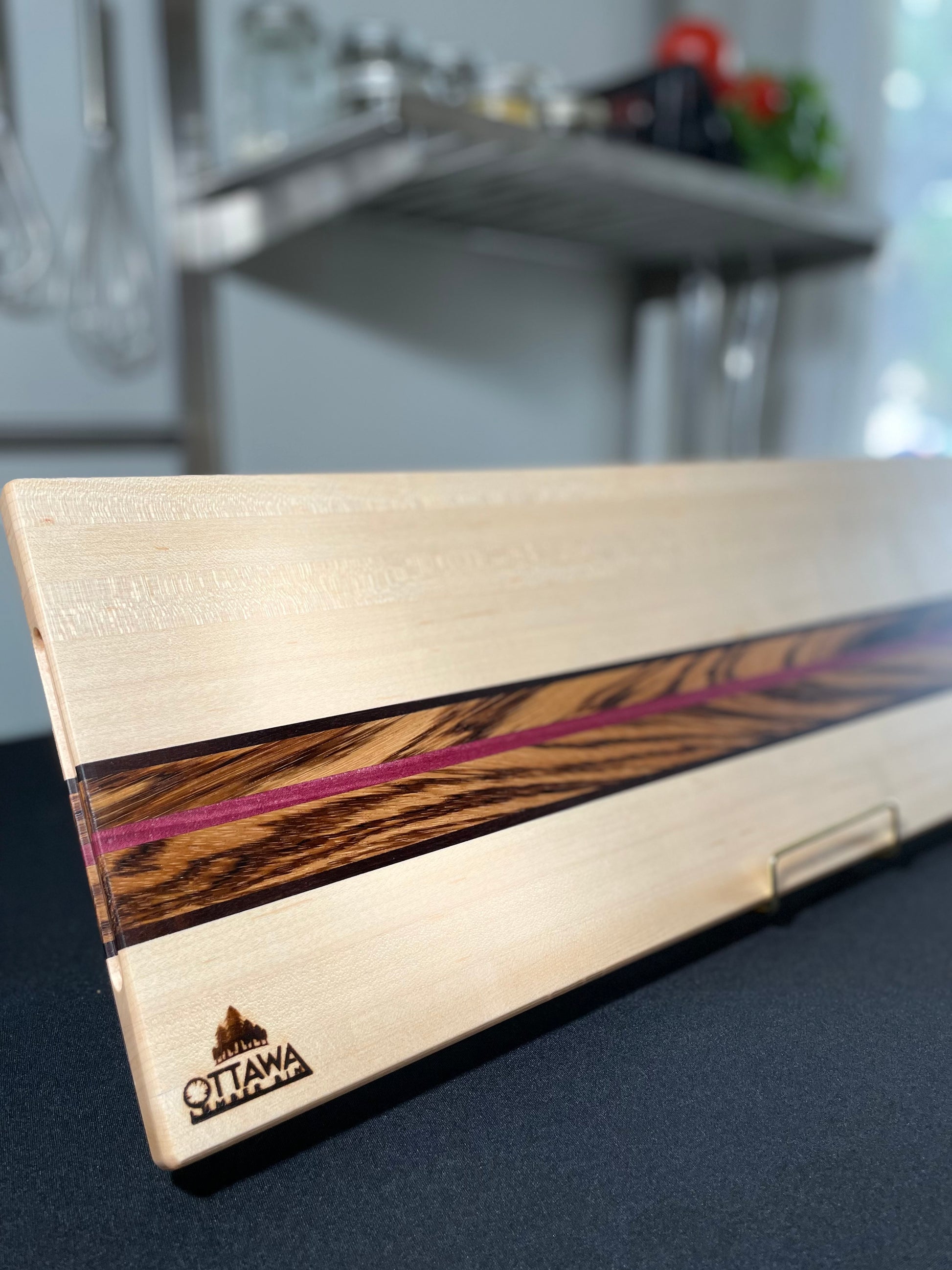 Zephyr handcrafted charcuterie board made from maple, zebrawood, walnut and Purpleheart.