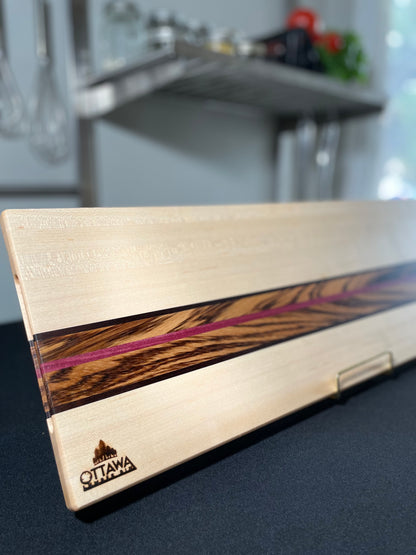 Zephyr handcrafted charcuterie board made from maple, zebrawood, walnut and Purpleheart.